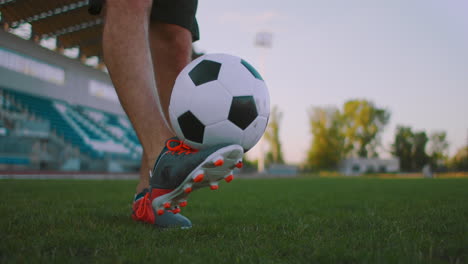 Professional-soccer-player-is-juggling-a-ball.-socker-a-player-in-a-white-football-uniform-at-the-stadium